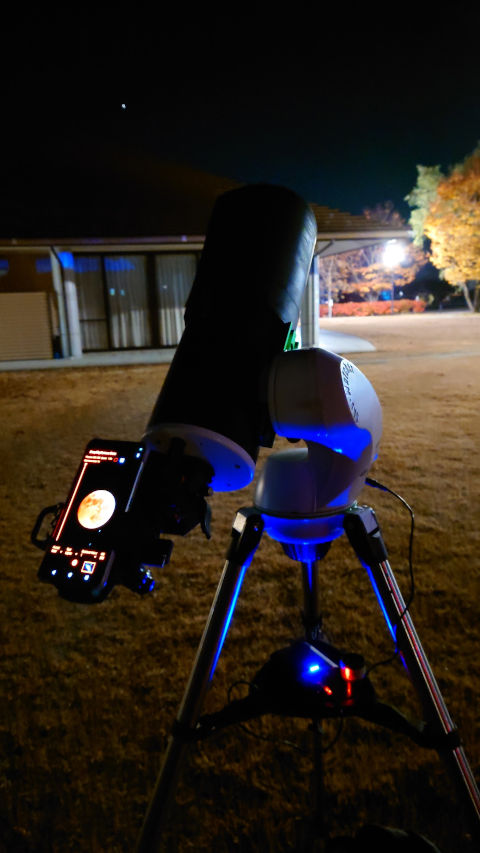 望遠鏡とスマホで月食をライブビューしている様子